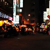 Under the rails: Patrons gather in the Yokocho area of Chiyoda Ward to drink with friends. Establishments in the area are offering two months of discounts to non-Japanese customers as a way to welcome tourists and visitors. | STEVE TRAUTLEIN PHOTOS