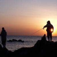 The slow life: Fishermen from Arasaki on the Miura Peninsula cast their lines at sunset. | ROBERT DE VIDO PHOTOS