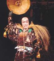 The tragic hero Takechi Mitsuhide reveals himself in “Ehon Taikoki,” on the left as played by kabuki actor Nakamura Hashinosuke, on the right, as a puppet handled by Kiritake Kanjuro. Tale of treason
