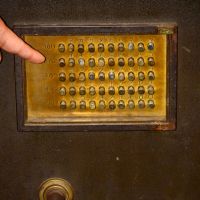 Rich rewards: At his Safe and Key Museum &#8212; where a 1937 military safe (above) is among the items on display &#8212; Yasushi Sugiyama shows off an antique key shaped to fit round a pillar. | UENO ZOO