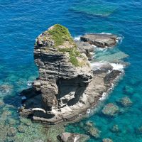 A world of its own: Spectacular coastal scenery (above) and \"major roads\" like this (below) may come as a culture shock to big-city visitors, though Yonaguni\'s doughty hanazake &#8212; being hand-labeled (pictured, bottom) &#8212; can help to ease any frazzled nerves. | STEPHEN MANSFIELD PHOTOS