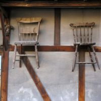 High seats: Windsor chairs hang as signs on the wall outside the Matsumoto Mingei Kagu furniture factory. | WINIFRED BIRD