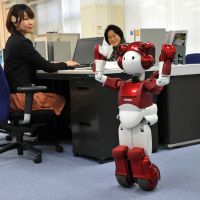 New recruit: EMIEW2, a humanoid service robot with the ability to communicate, struts its stuff at Hitachi Ltd.\'s research laboratory in Kokubunji, Tokyo. | KYODO PHOTO