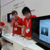 Hand-held interpreter: NTT DoCoMo Inc. workers demonstrate how to use a smartphone-based translation service at Wireless Japan 2012 at Tokyo Big Sight on June 1. | KAZUAKI NAGATA
