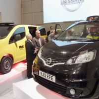 Ready to roll: A Nissan Motor Co. NV200 minivan (right) is displayed in London on Monday. The model was chosen to join the fleet of black cabs in the capital from the spring of 2014. On the left is the New York taxi version of the same model. | KYODO