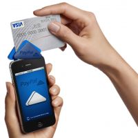 Phone-hacking risk?: A smartphone can work as a credit card reader by attaching a PayPal Here system to it. | SOFTBANK CORP.