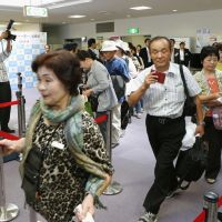 Climbing back: Passengers prepare Monday to board a China Eastern Airlines chartered flight bound for Shanghai at Fukushima Airport, which resumed international services for the first time since the March 2011 disasters. | KYODO