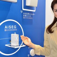 For the home: A model shows off the AiSEG, Panasonic Corp.\'s new energy-management device for the home, during a media preview  Tuesday in  Tokyo. | KYODO