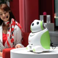 At your service: NTT DoCoMo demonstrates a robot that recognizes voices and provides personalized assistance at the CEATEC electronics trade show at Makuhari Messe in Chiba Prefecture on Tuesday. | AFP-JIJI