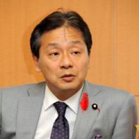 High finance: Ikko Nakatsuka, the newly appointed state minister for financial issues, is interviewed by a group of reporters Friday. | SATOKO KAWASAKI