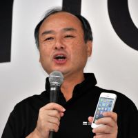 Man of the hour: Softbank President Masayoshi Son speaks at a launch ceremony for the Apple iPhone 5 at a Softbank mobile phone shop in  Tokyo on Sept. 21. | AFP-JIJI