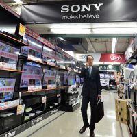 Screening process: A customer browses through Sony LCD TVs at an electronics shop in Tokyo on Thursday. | AFP-JIJI