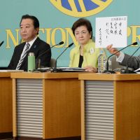 Agreeing to disagree: Nippon Ishin no Kai leader Shintaro Ishihara holds a sign at a debate with 10 other party chiefs at the Japan National Press Club in Tokyo on Friday, including (left to right) Liberal Democratic Party President Shinzo Abe, Democratic Party of Japan leader Yoshihiko Noda and Nippon Mirai no To head Yukiko Kada. | AFP-JIJI
