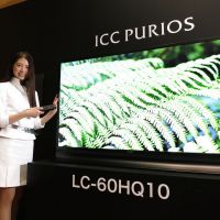 Latest and greatest: A model shows off Sharp Corp.\'s 60-inch ICC Purios TV Thursday in Minato Ward, Tokyo. | KAZUAKI NAGATA
