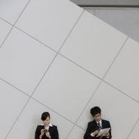 In touch: University students use smartphones at a job fair in Tokyo in December. | BLOOMBERG