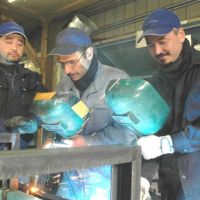 Torch-bearers: Welders (from left) Jonhson Toshio Maeda, Marcos Vinicio Garcia Irala and Marcero Chiba work on equipment at Bunshodo Corp. in Kani, Gifu Prefecture. | CHUNICHI SHIMBUN