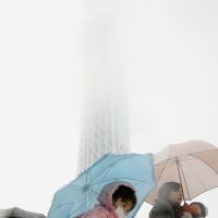 Good-packing: Tokyo Sky Tree in Sumida Ward vanishes in snow Wednesday as a mother and her kids pass by. | KYODO
