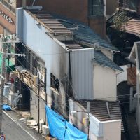 Crime scene: Police guard the building that housed the Ammy bar in Himeji, Hyogo Prefecture, after a man set it on fire, killing one person and injuring himself and three others Saturday. | KYODO