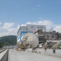 Before and after: The heavily damaged Yayoi Foods Co. plant in Kesennuma is seen on May 27, more than two months after the March 11 tsunami. Below, the same plant on Feb. 22. | SETSUKO KAMIYA