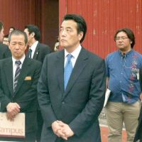 Looking to bond: Deputy Prime Minister Katsuya Okada visits Shuri Castle in Naha, Okinawa Prefecture, on Saturday before attending a symposium on tax and social reforms. | KYODO
