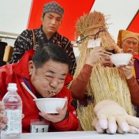 Stuffing his face: A competitor grimaces as he tries to bolt down \"natto\" fermented beans during  a speed-eating contest in Mito, Ibaraki Prefecture, on Saturday. | KYODO