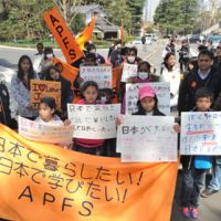Fighting to stay: Foreigners who have overstayed their visas rally Monday in Tokyo\'s Hibiya district, calling for the Justice Ministry to grant them special residency permits. | YOSHIAKI MIURA