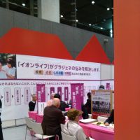 The inevitable: Visitors to Aeon Co.’s funeral services exhibition listen to representatives in April at the Tokyo International Forum in Chiyoda Ward. Part of aging process: Preparing for the end