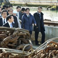 Leading the way: Prime Minister Shinzo Abe visits a shipbuilder in Ishinomaki, Miyagi Prefecture, during a trip aimed at showing his commitment to disaster-hit areas in Tohoku on Saturday. | KYODO