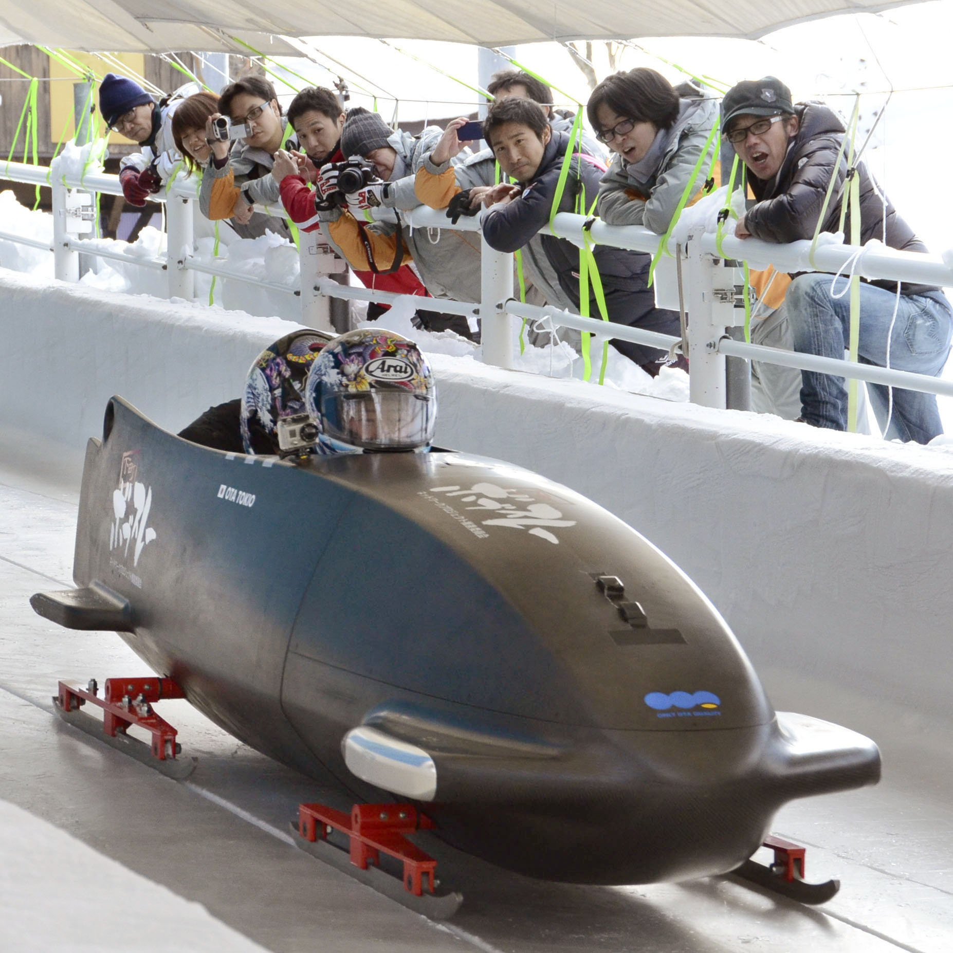 Bob in the track: Developers of the nation's first bobsled watch a December test run in the city of Nagano. | KYODO