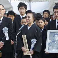 Actress Akiko Koyama, wife of film director Nagisa Oshima, greets mourners at his funeral Tuesday at Tsukiji Honganji Temple in Tokyo. | KYODO