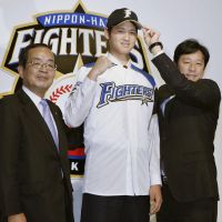 Formal introduction: Hokkaido Nippon Ham Fighters pitcher Shohei Otani meets the press on Tuesday in Sapporo after he signed a contract. | KYODO