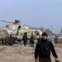 Flights suspended: In this image taken from a video obtained by Ugarit News, rebel troops capture a helicopter base near Damascus on Sunday. | AP