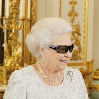 Modern monarch: Queen Elizabeth II wears 3-D glasses to watch the recording of her Christmas message from Buckingham Palace on Sunday. | AFP-JIJI