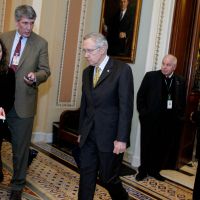 Questionable influence: Senate Majority Leader Harry Reid walks from the Senate chamber to a caucus in the Capitol on Dec. 30. Reid is just one of many lawmakers whose family members are also lobbyists. Relatives of U.S. lawmakers lobby on bills before Congress