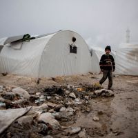 Destitute: A Syrian boy walks near garbage at a refugee camp near the city of Azaz, close to the border with  Turkey, on  Tuesday. | AFP-JIJI