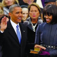 Encore: President Barack Obama receives the oath of office from Chief Justice John Roberts as first lady Michelle Obama holds two Bibles and watches during the ceremonial swearing-in at the U.S. Capitol in Washington on Monday. | AP