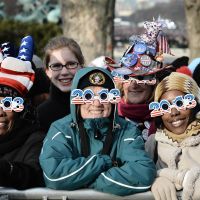 Eyewitnesses to history: Americans celebrate the ceremonial swearing-in near the U.S. Capitol on Monday. | AFP-JIJI