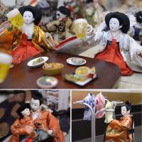 Empress hina dolls attending a \"joshi-kai\" (women-only party) raise beer mugs while their male counterparts are at home looking after the baby and hanging the laundry.  | KYODO PHOTO