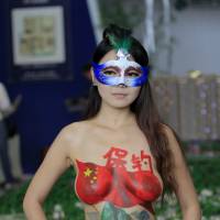 Power of paint: A model with a body painting of disputed islands known as the Diaoyus in China and the Senkakus in Japan protests in Nanjing, China, last September. | AFP-JIJI