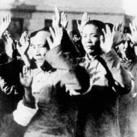 Chinese citizens hold their hands up in the documentary \"Nanking,\" directed by Bill Guttentag and Dan Sturman | THINKfilm