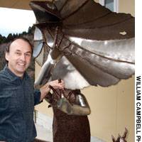 Wine impresario Richard Cohen (avobe) proudly posing with a 1,000 kg. stainless-steel scuplture of a frilly necked Australian lizard in front of the Village Cellars\' headquarters in Toyama Prefecture | PHOTOS COURTESY OF THEATRE COCOON