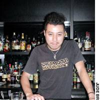Manager Kentaro Sasou (above) mans the bar at 08:30 Music Simulation Bar, where you can belt out a Radiohead tune, like this customer above, or join the house band on any instrument you like. | PHOTOS COURTESY OF KINOKUNIYA HALL