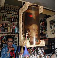 A replica of the head of the Bride of Frankenstein (from the 1935 horror movie of the same name) watches over horror bar Furanken-no-Hana-yome as the Bride\'s devoted servant, master Hidehikoi Oki, looks on. | COURTESY OF BONPOINT, ISETAN, HAKKA