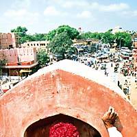 A plasterer works on the Chandpol Gate overlooking Jaipur\'s bustling streets. | PHOTOS COURTESY OF LE THEATRE GINZA AND NITO-SHA