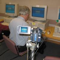 A judge\'s conversation with a chatterbot -- or is it a human? -- is videoed for relay to onlookers at this year\'s Loebner Prize contest, Oct. 18 | COURTESY OF BRIDGET RILEY 2003/COURTESY OF KARSTEN SCHUBERT LONDON