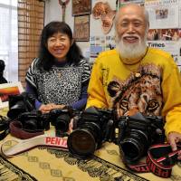 Out of Africa: Michio Hiraiwa and his daughter, Masayo, pose at their African photo and craft gallery in Tokyo\'s Suginami Ward. The duo have traveled to Kenya together nearly 140 times and taken a total of 3,700 Japanese tourists to the country.
 | YOSHIAKI MIURA