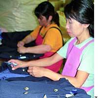 Workers at textile-trading firm Chikuma &#38; Co. in Osaka remove buttons and logos from the old uniforms of Japan Airlines Co. and Japan Air System Co. before they are recycled. | TAIGA URANAKA PHOTO
