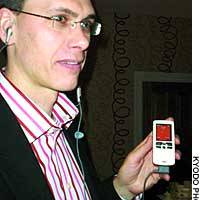 A man holds the Sony Ericsson W800, the first Walkman-brand mobile phone, during its European launch. | TAIGA URANAKA PHOTO