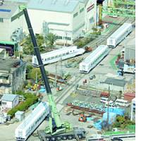 A crane hoists shinkansen-type train cars destined for China at Kawasaki Heavy Industries Ltd.\'s factory in Kobe on Friday. | YONHAP/KYODO