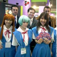Anime insider writers Andres Bergen (back, right), Jon Baumgardner (back,left) and editor Robert Bricken pose Thursday with costumed female workers at the Tokyo International Anime Fair 2006. | YONHAP/KYODO